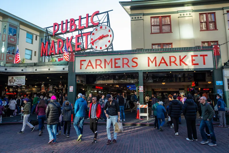 Visitors walk through Pike Place Market in Seattle, Washington.